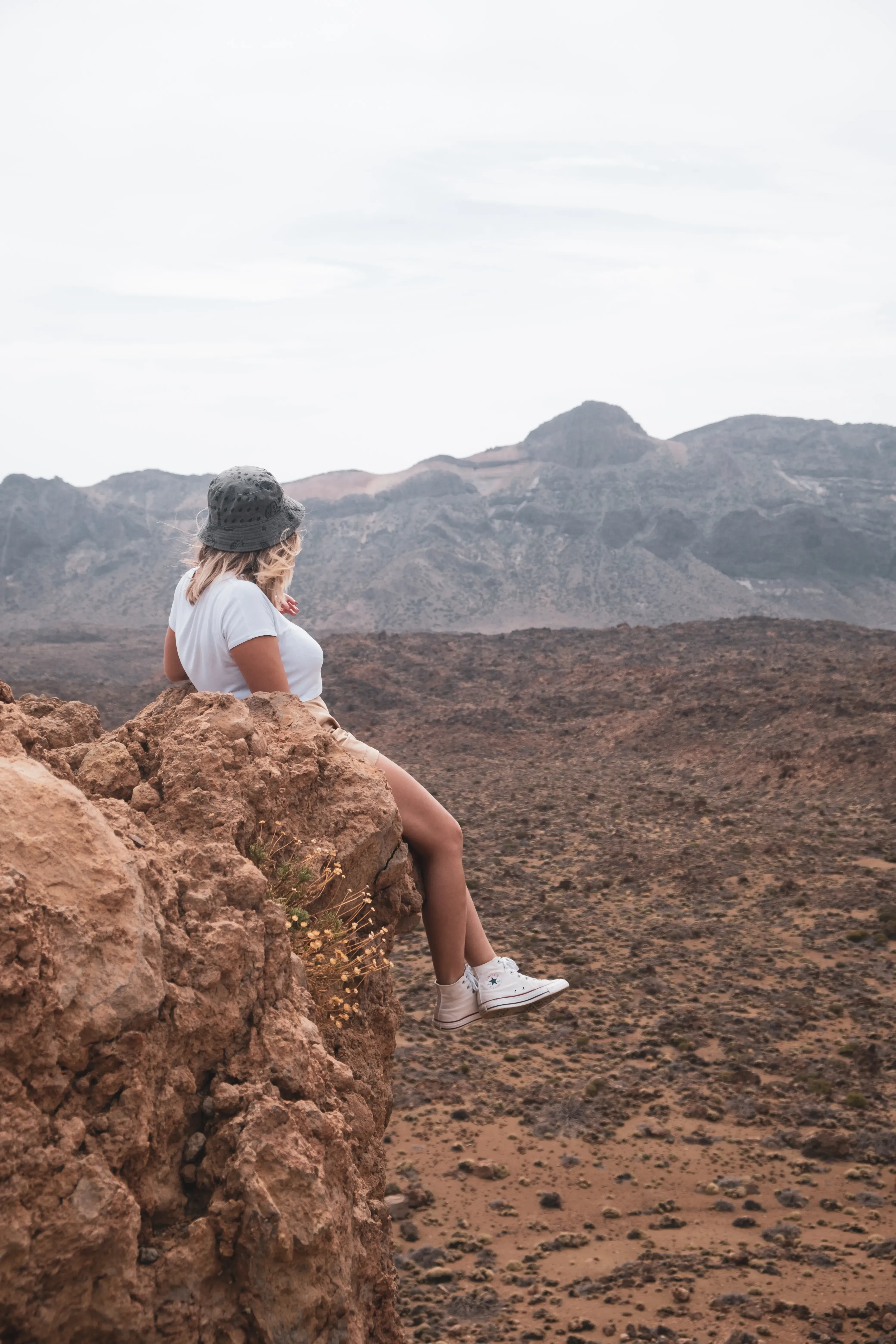 Letizia sitting in the unique, arid, and volcanic landscape near the base of Mount Teide in Tenerife.