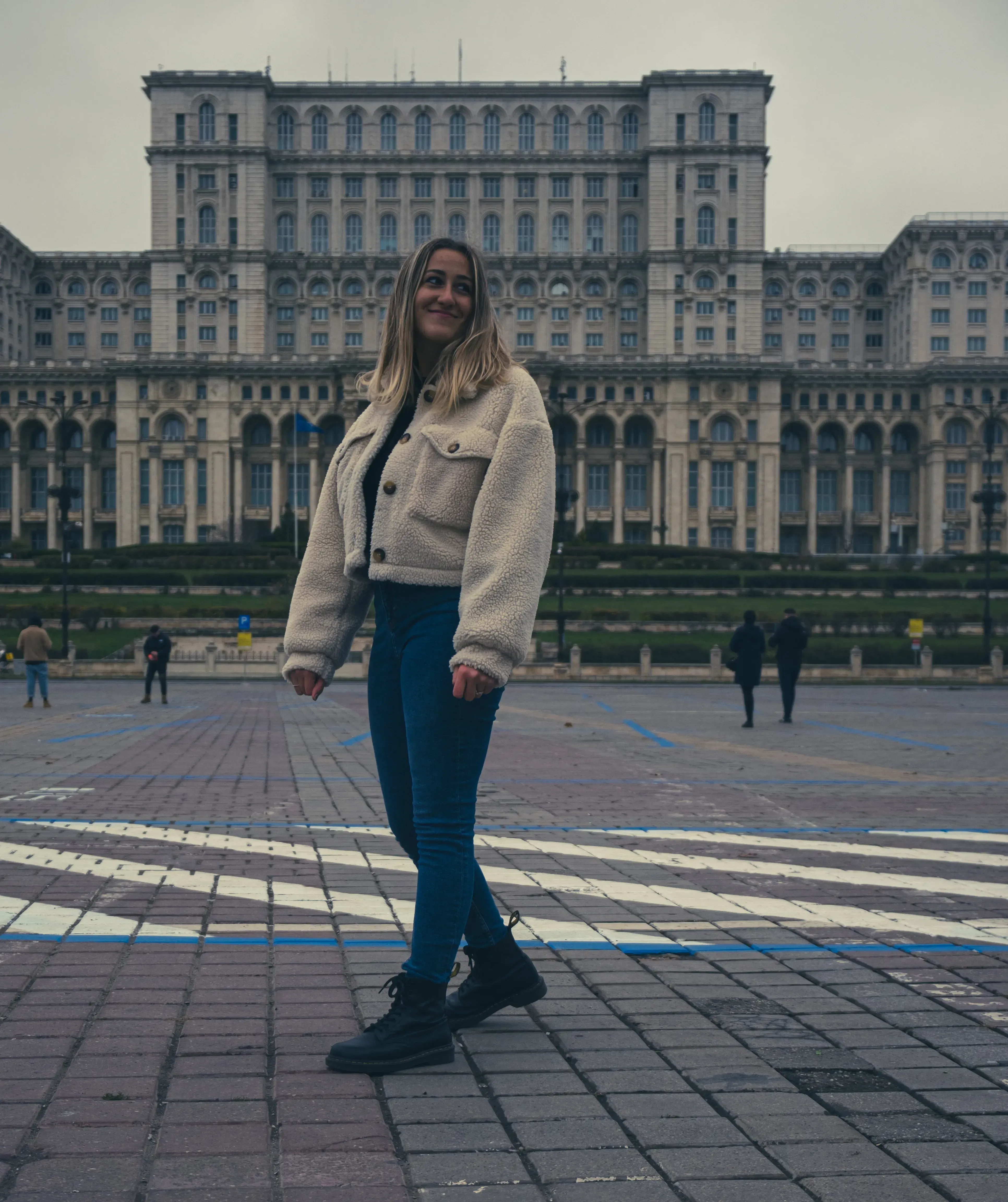 Letizia posing in Bucharest with the immense Palace of the Parliament building (Casa Poporului) visible in the background.