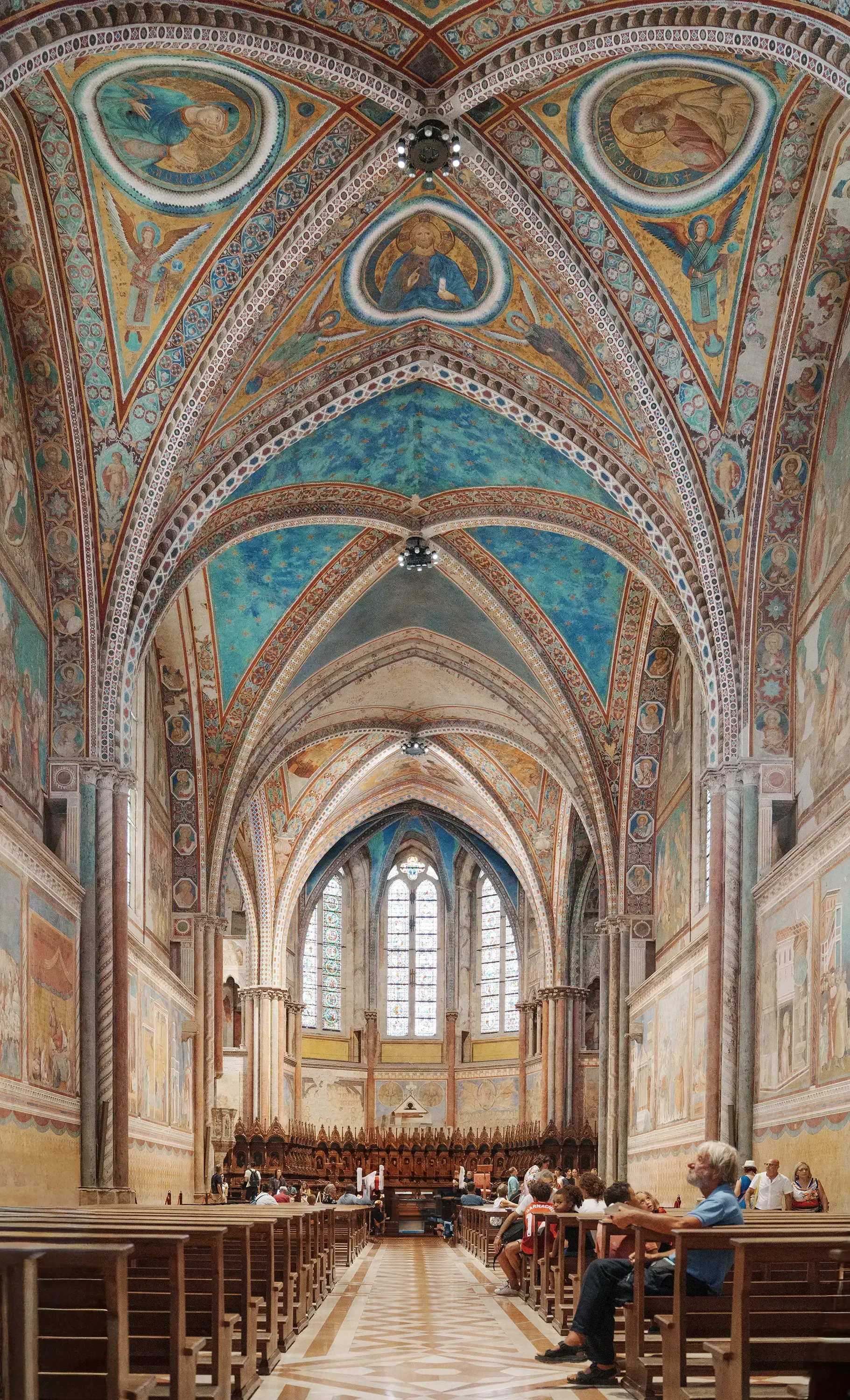Detailed view of the frescoed vaulted ceiling inside the Basilica of Saint Francis of Assisi.