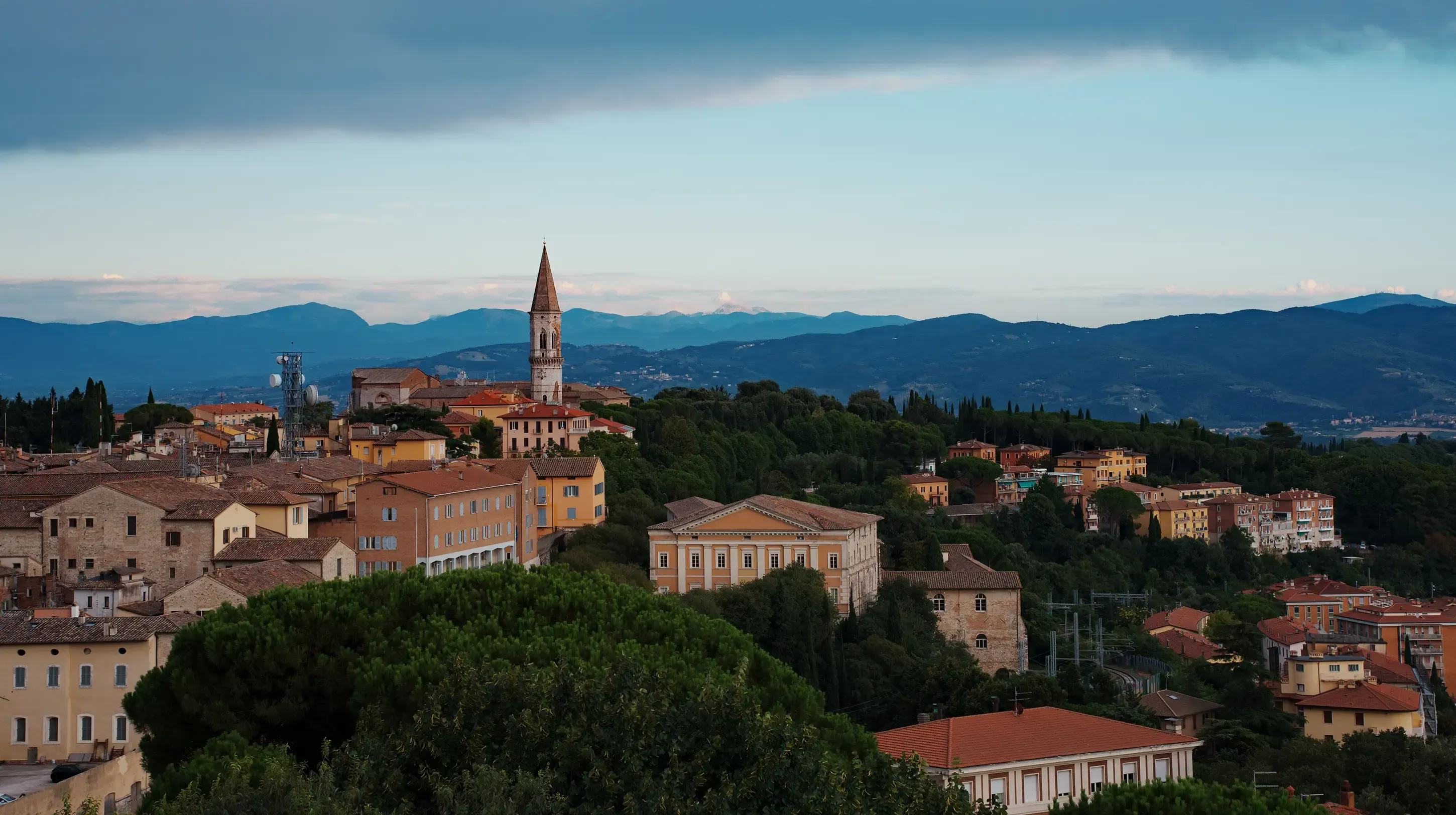 View through the arches of the bell tower (Campanile) showing the cityscape of Perugia.