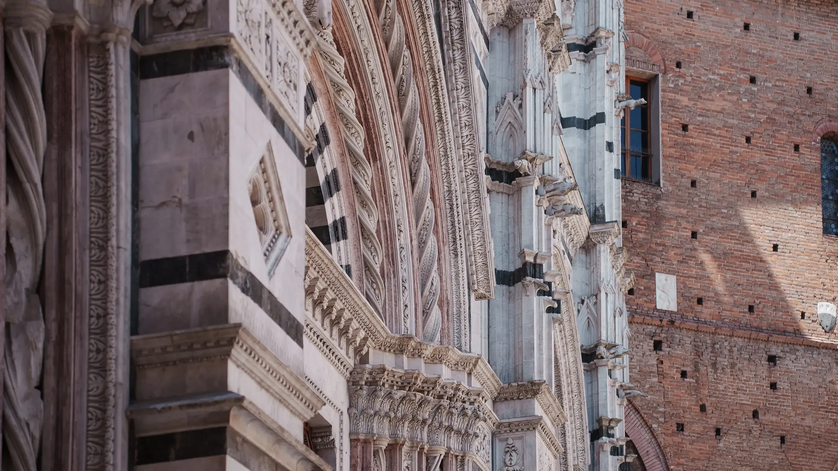 Detail of the ornate, twisted columns of the Siena Cathedral's interior architecture.