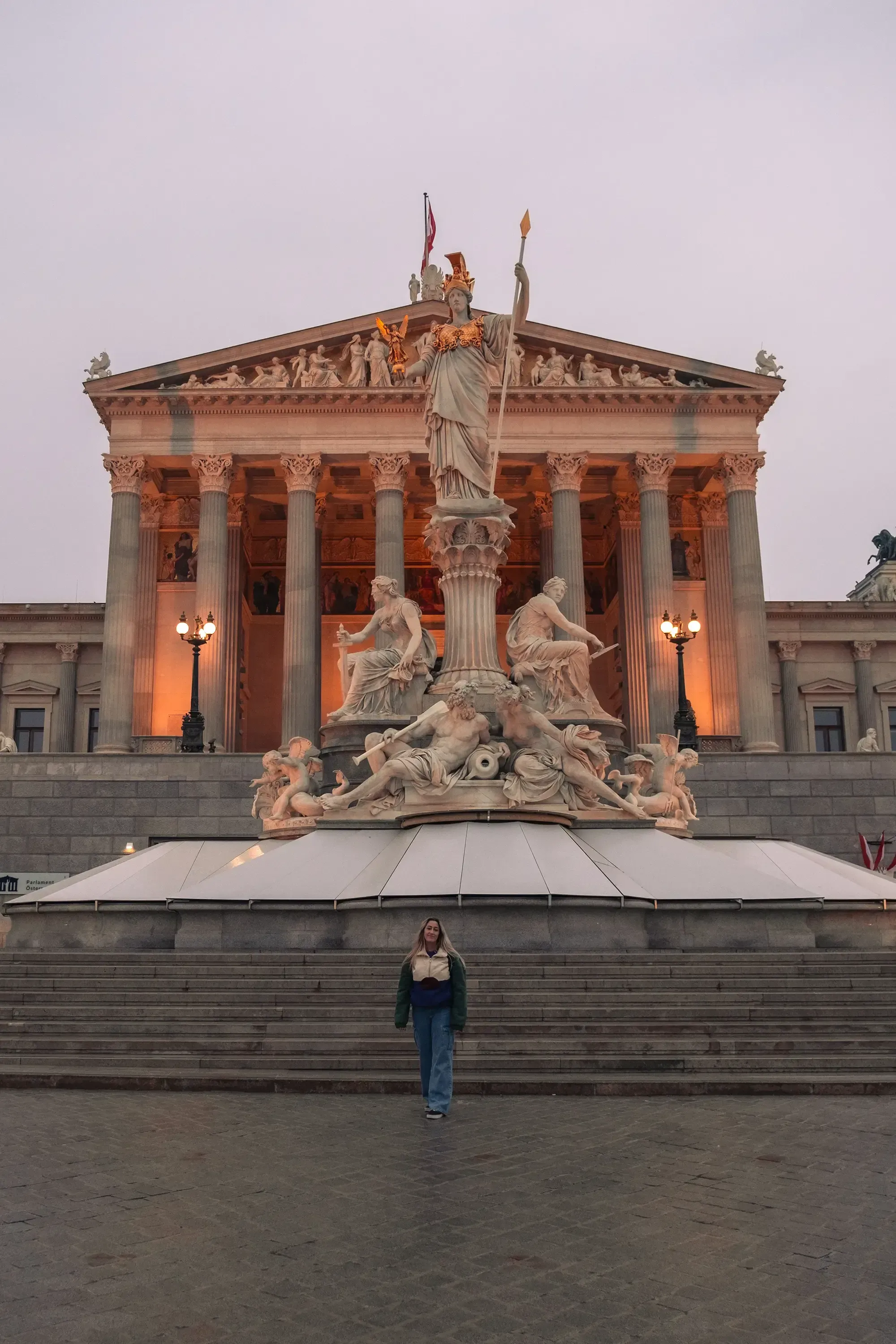Letizia posing in front of a famous statue depicting a Greek or Roman deity.