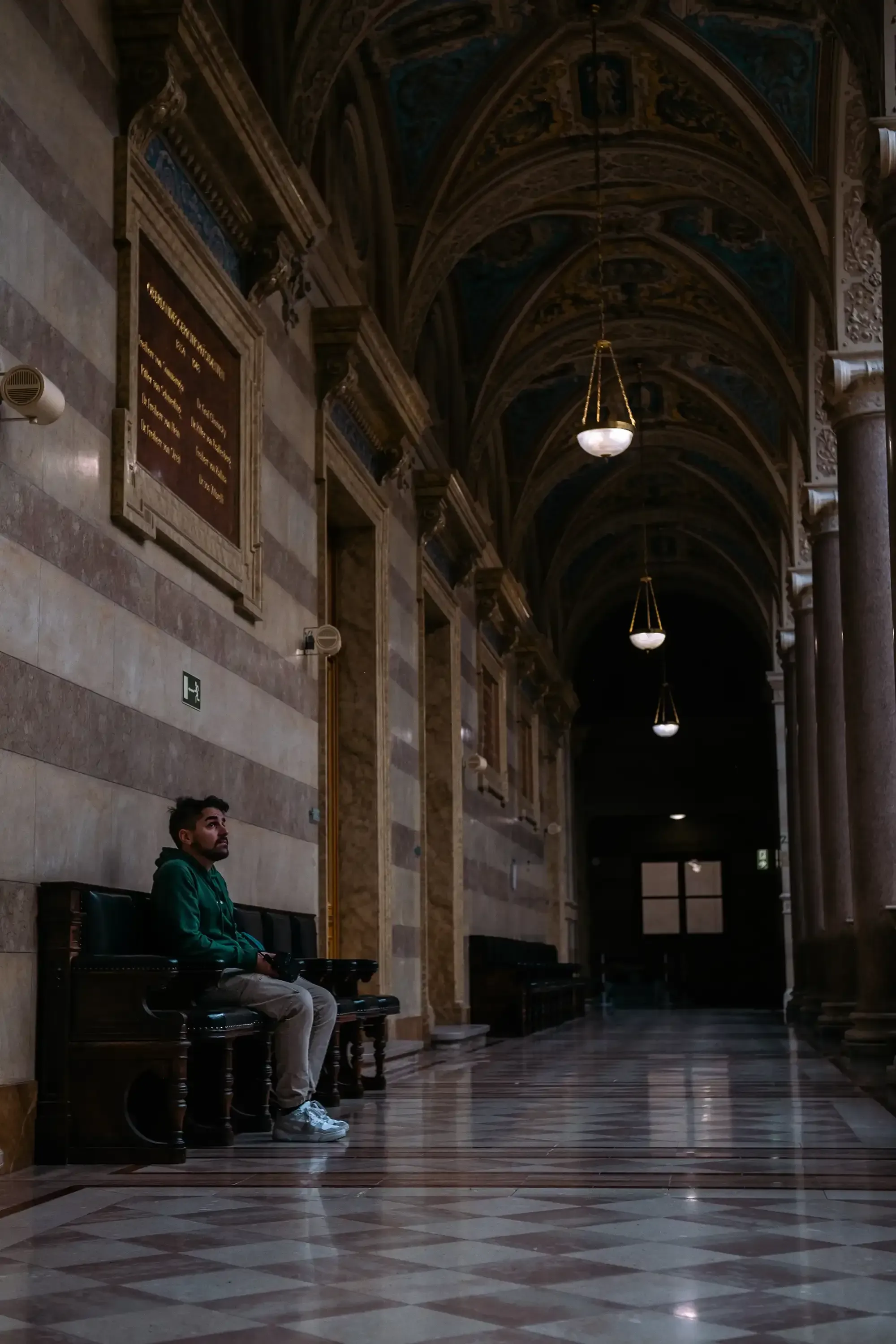 Ieser sitting inside the ornate hall or atrium of the Palace of Justice (Justizpalast).