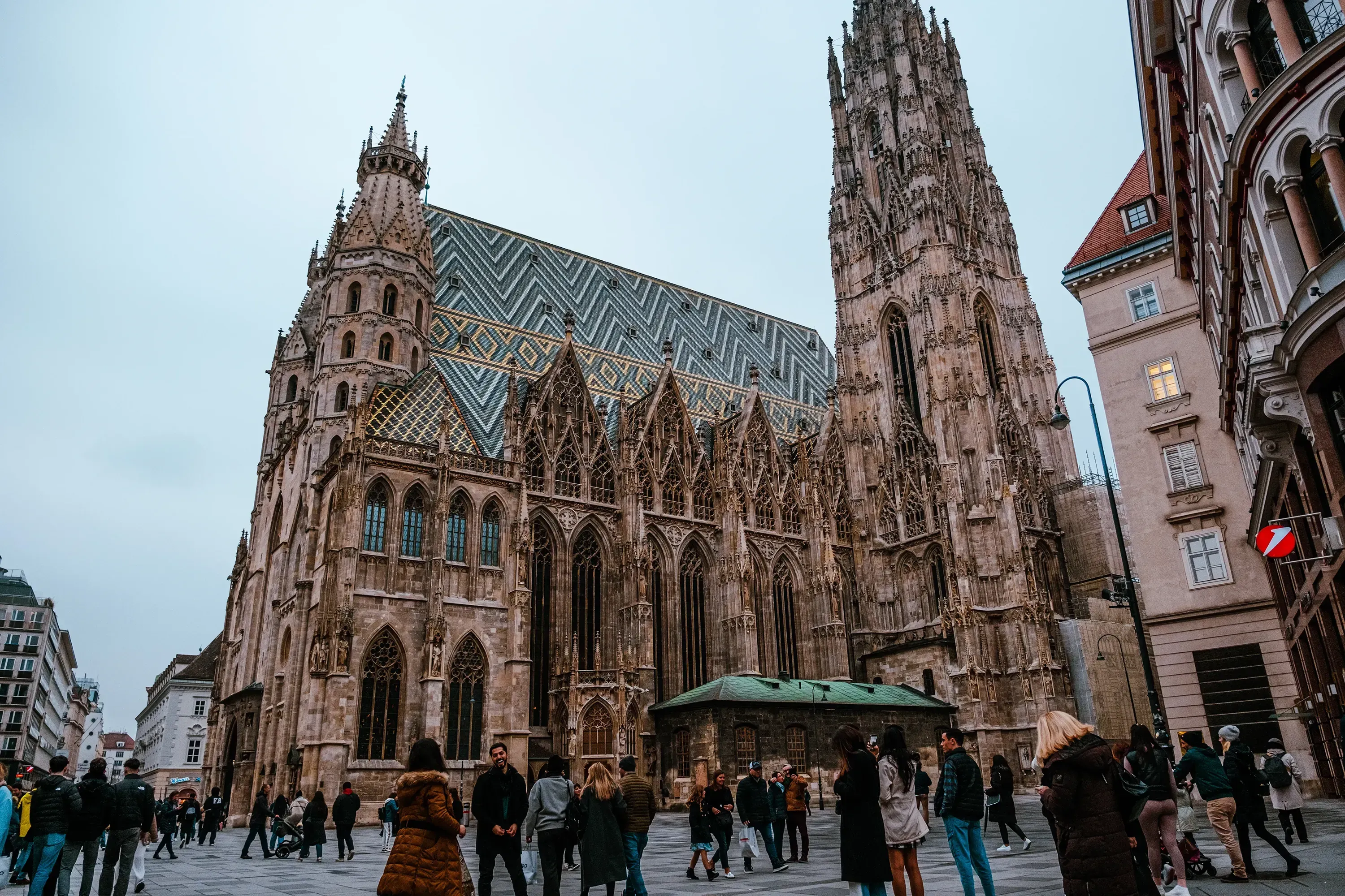 Low-angle view emphasizing the massive scale of St. Stephen's Cathedral (Stephansdom) spire.