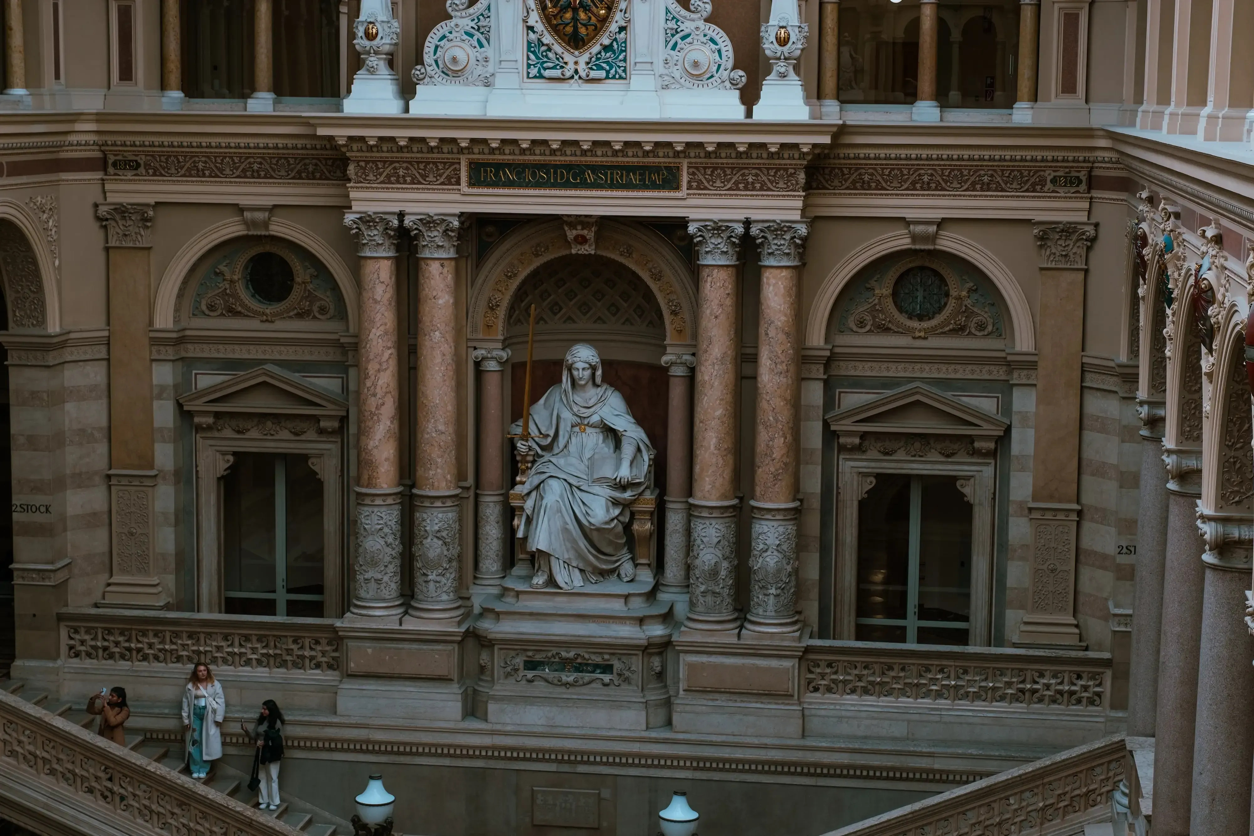 Close-up of a prominent statue within the Palace of Justice, perhaps depicting Lady Justice.