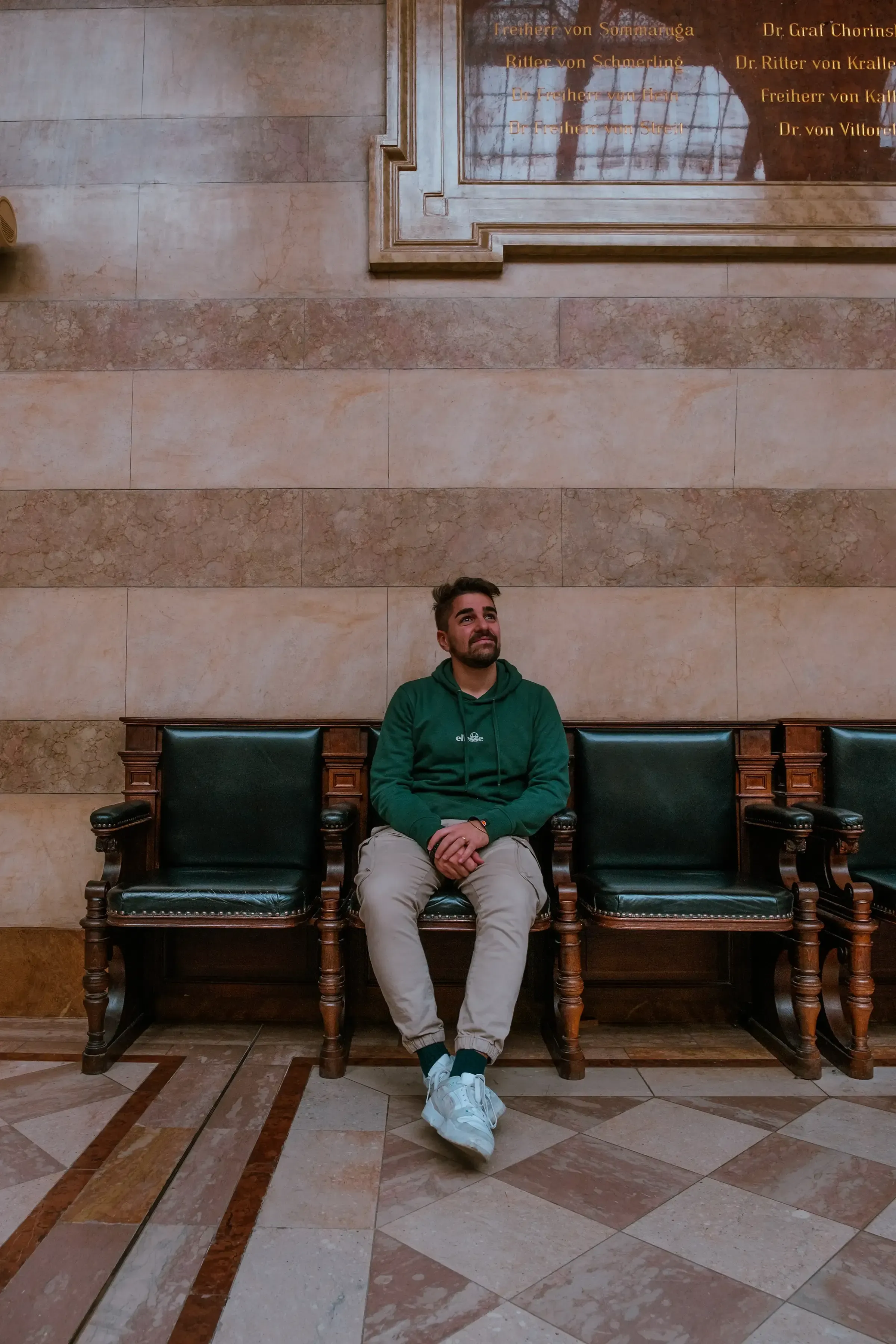 Ieser sitting inside the main hall or atrium of the Palace of Justice (Justizpalast).