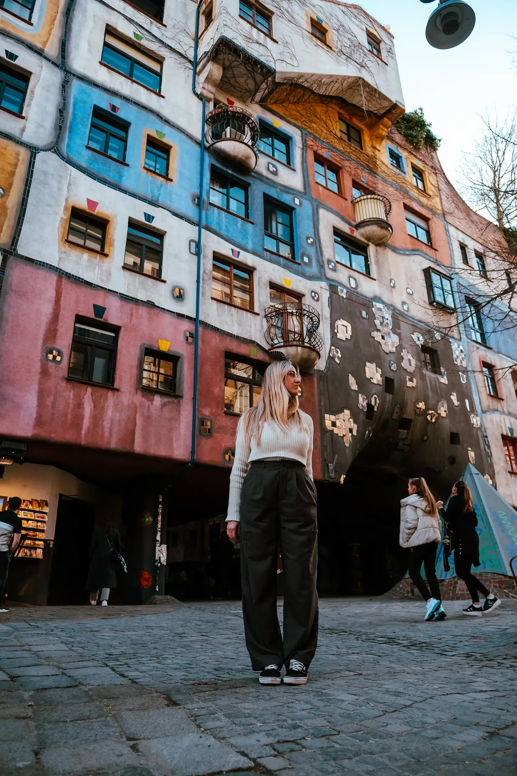 Letizia standing in the area of the colorful, distinctively designed Hundertwasser houses.