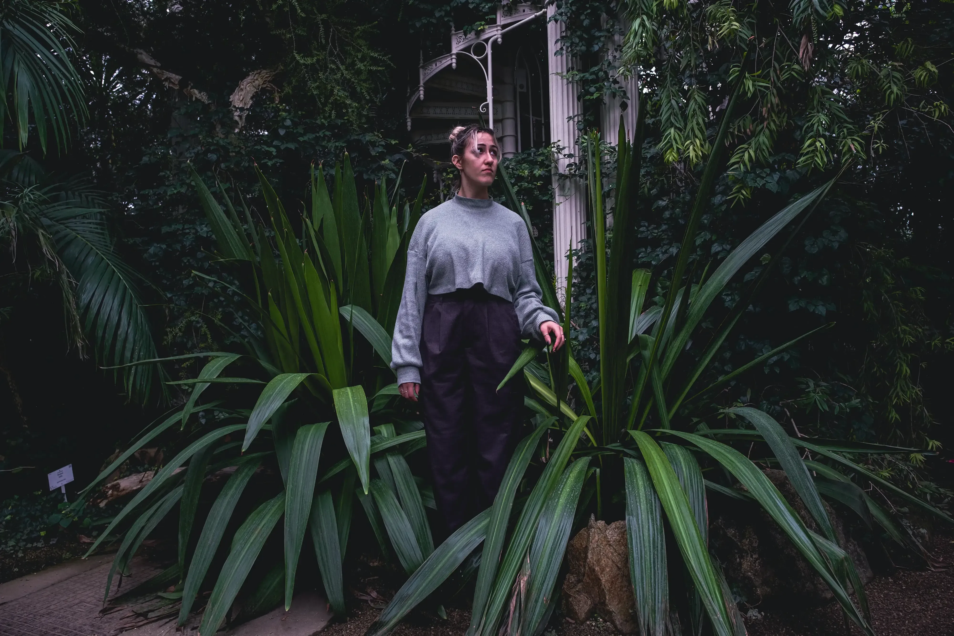 Letizia standing among the tropical plants inside the historic Palmenhaus (Palm House).